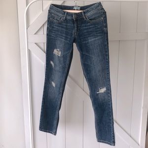 Dark distressed blue jeans